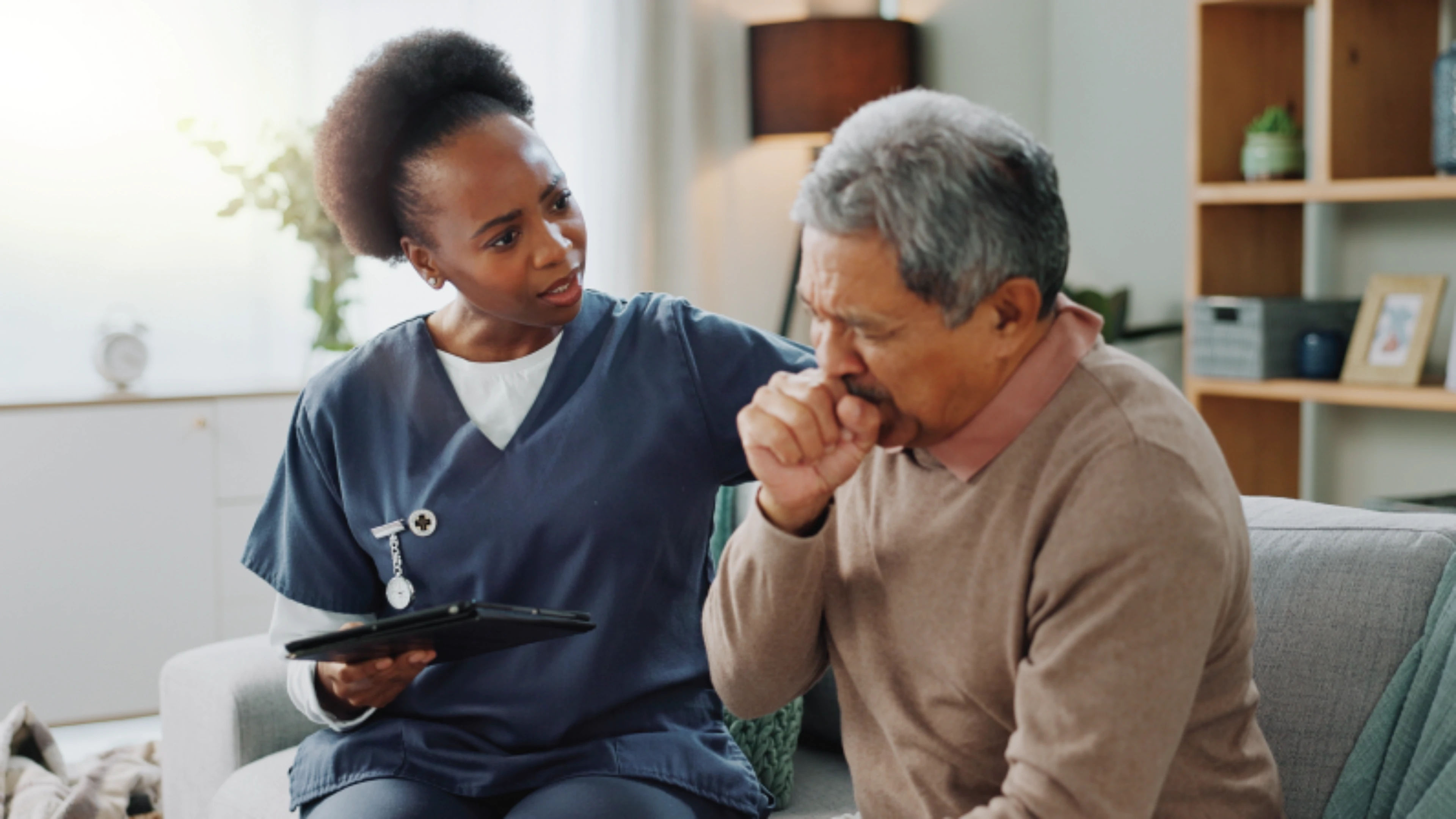 Doctor reassuring her coughing patient