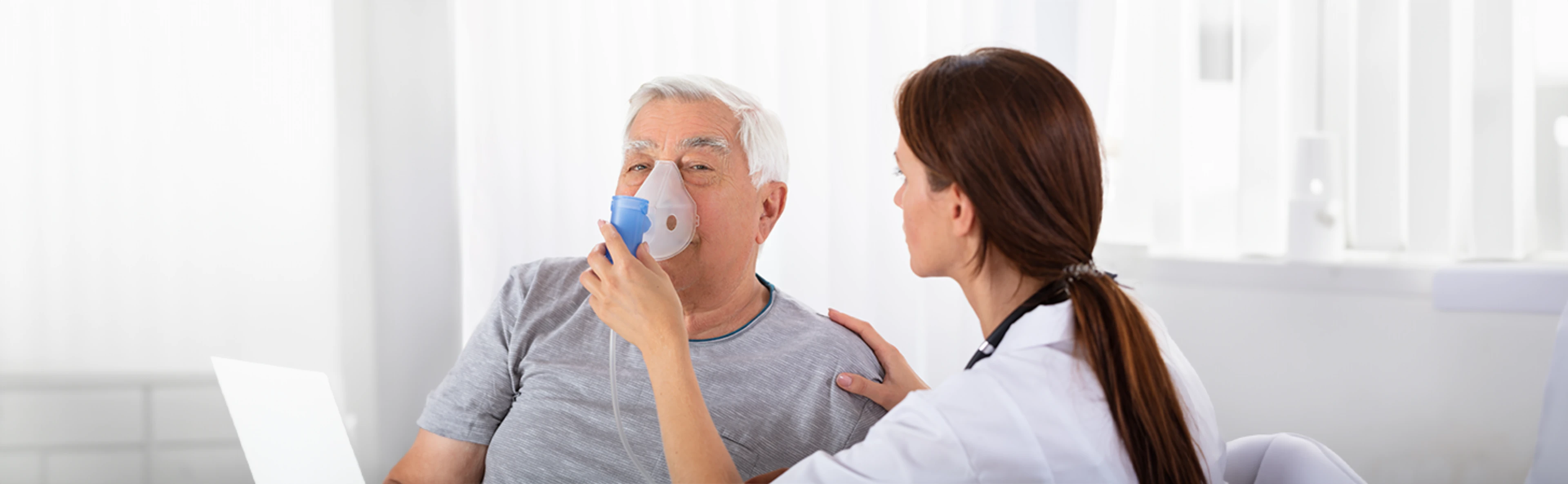 Nurse placing a respiratory mask on a patient