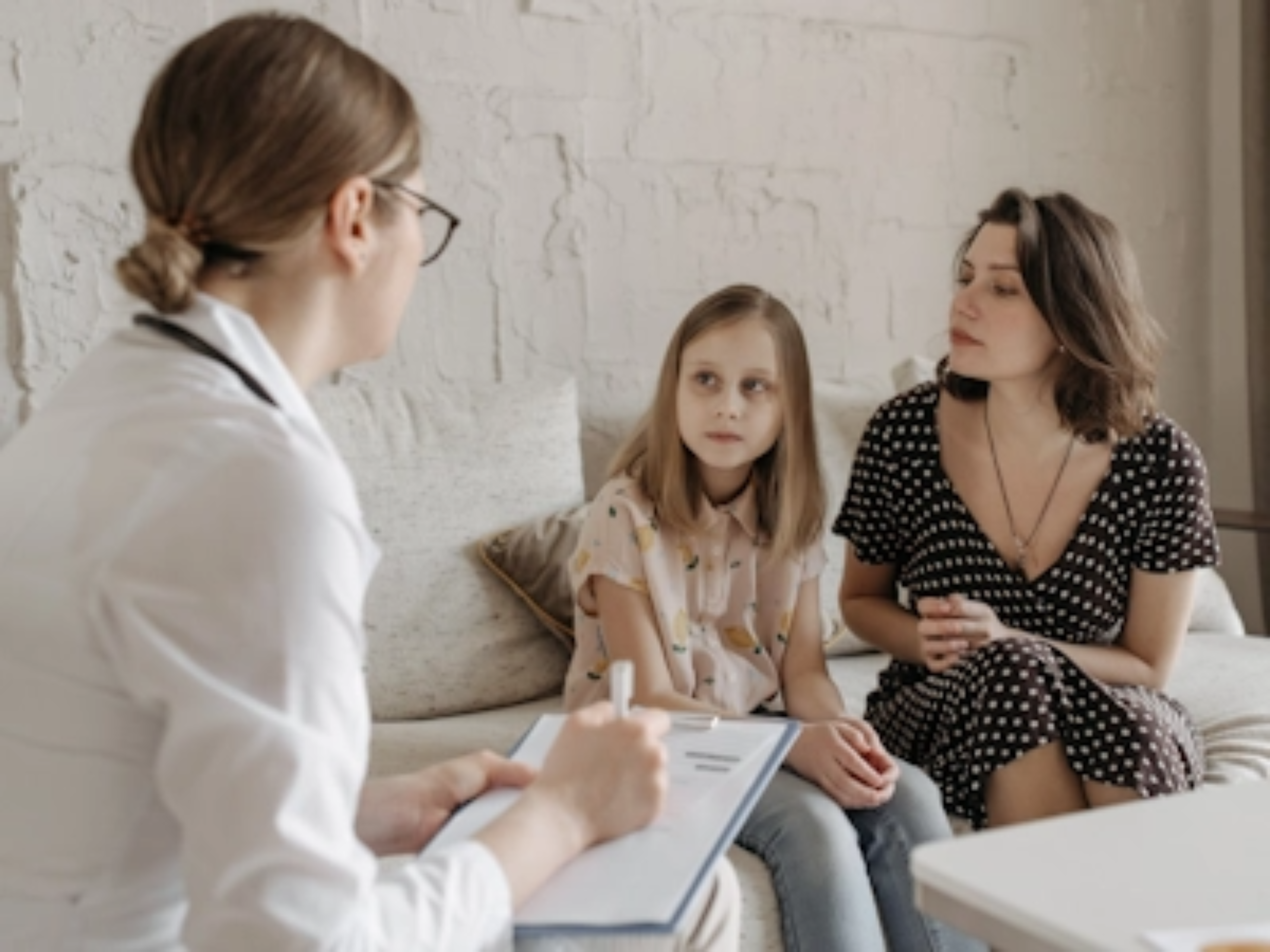 Eine Ärztin diagnostiziert ASMD bei einem Kind in Anwesenheit ihrer Mutter