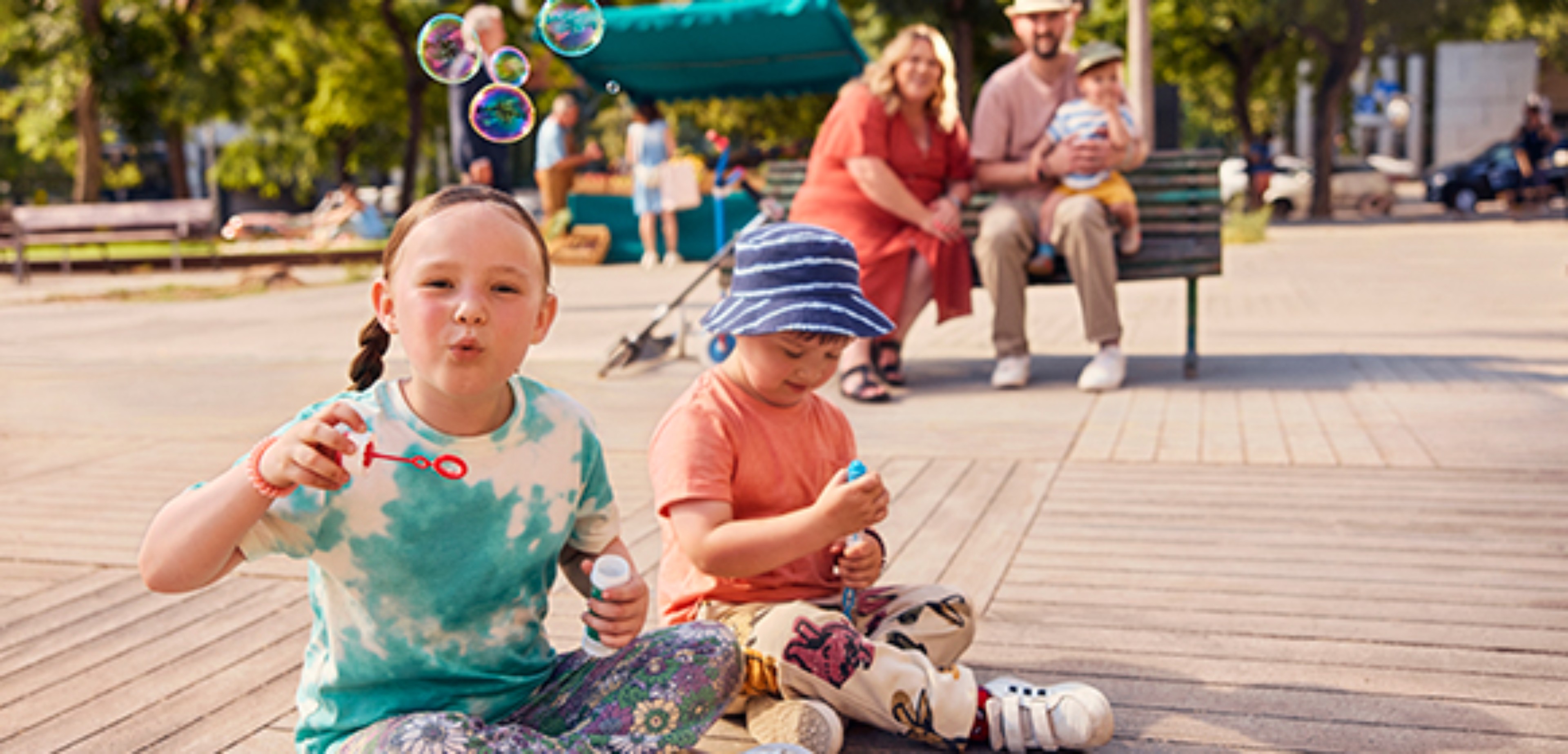 Two girls playing with bubbles on the street