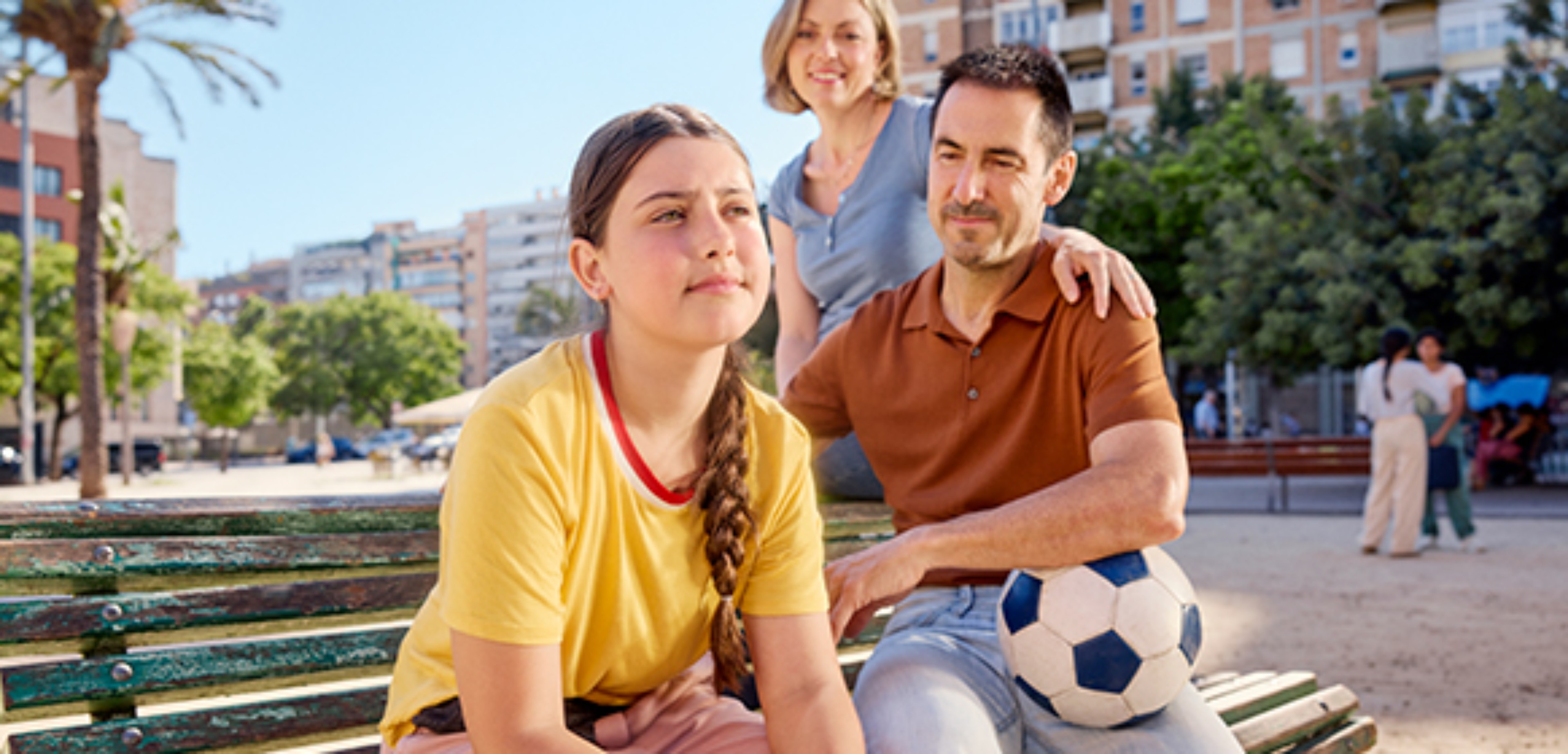 A family sitting on a bench