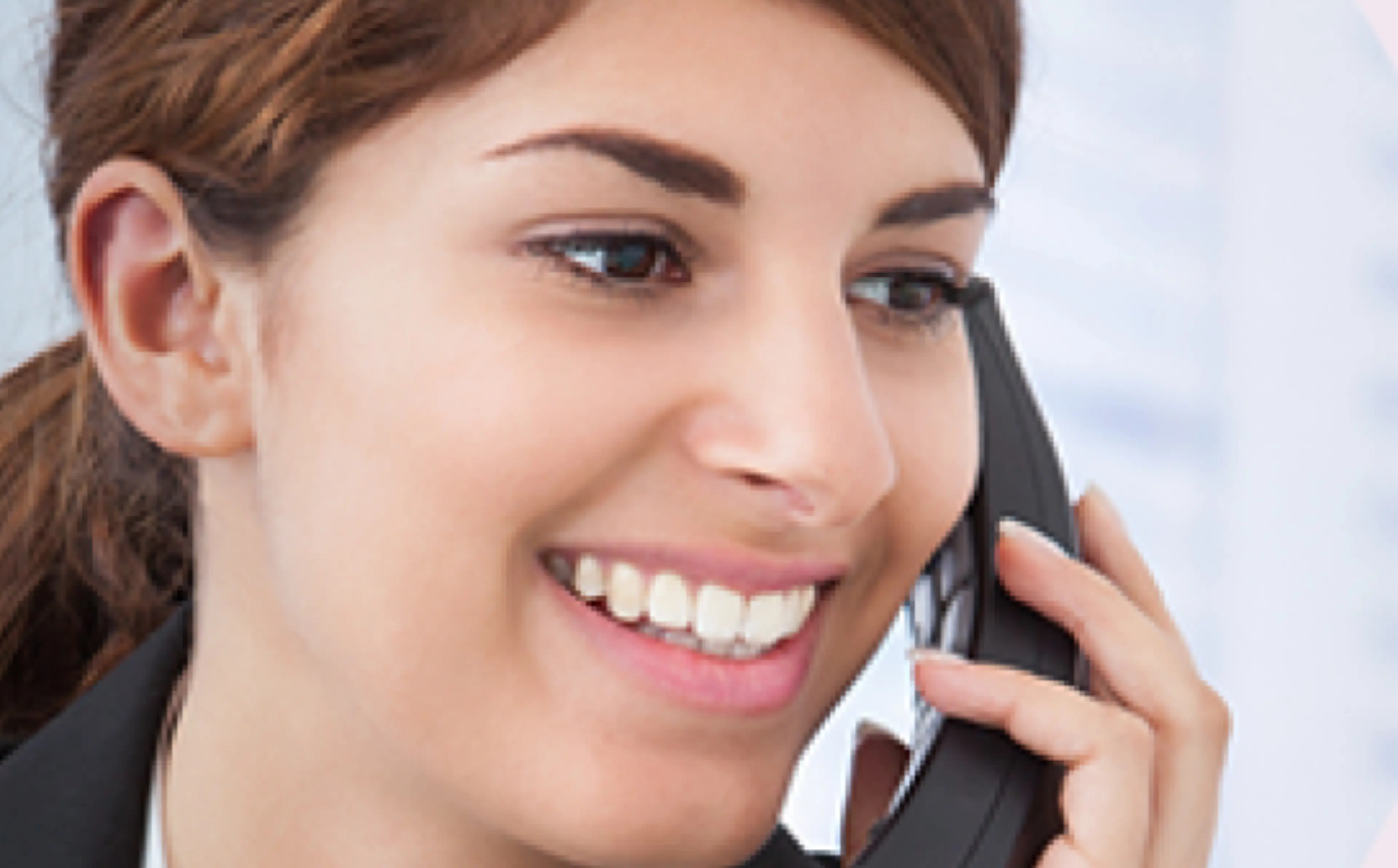 Woman smiles while speaking on the phone.