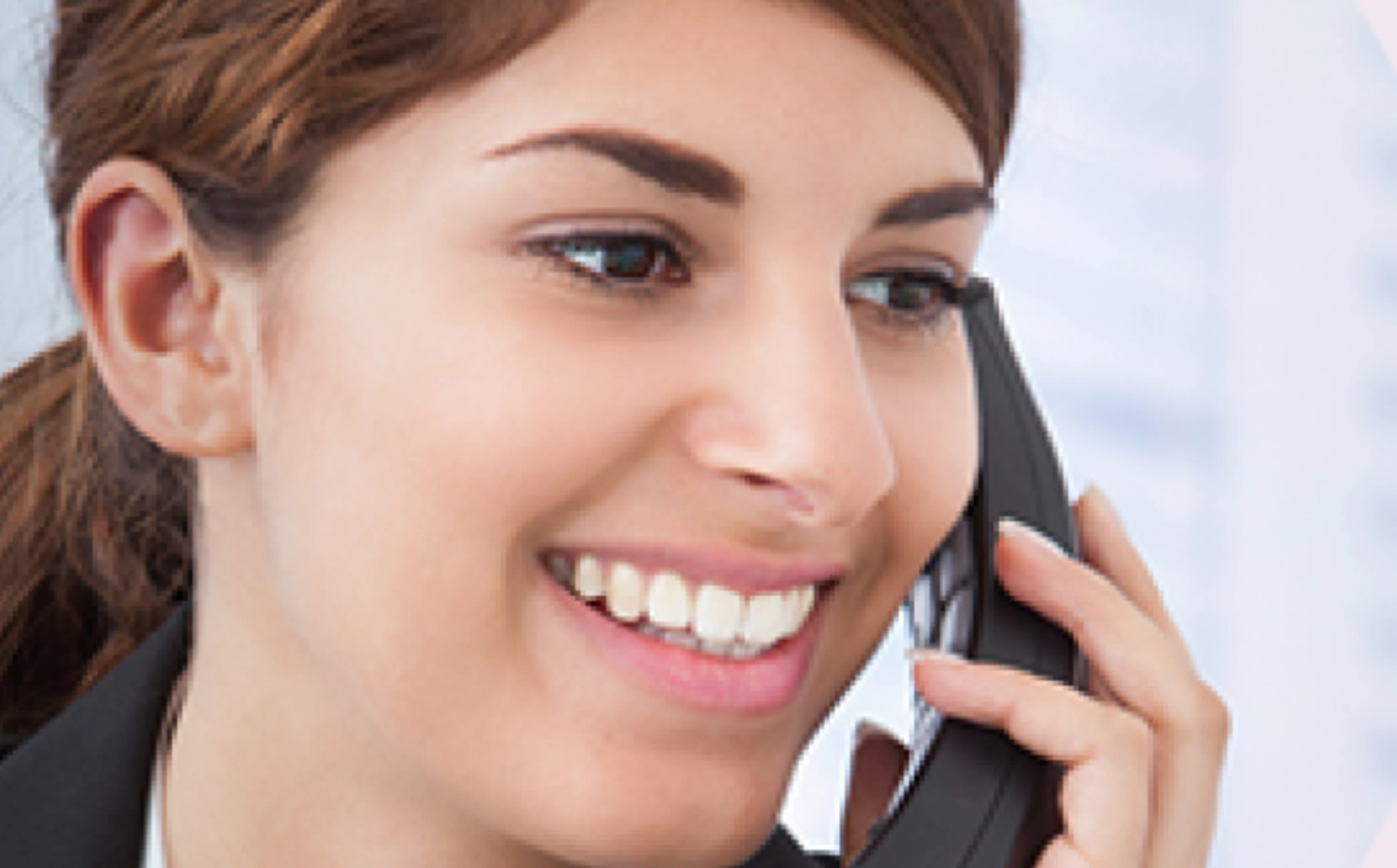 Woman smiles while speaking on the phone
