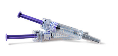 Two medical syringes with purple plungers and labeled text on them.