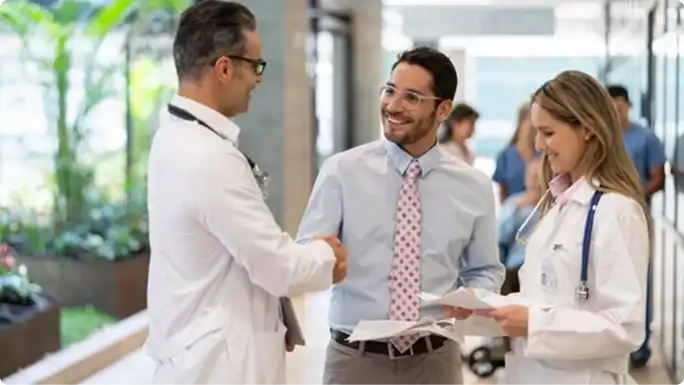 Two healthcare professionals communicating with an agent