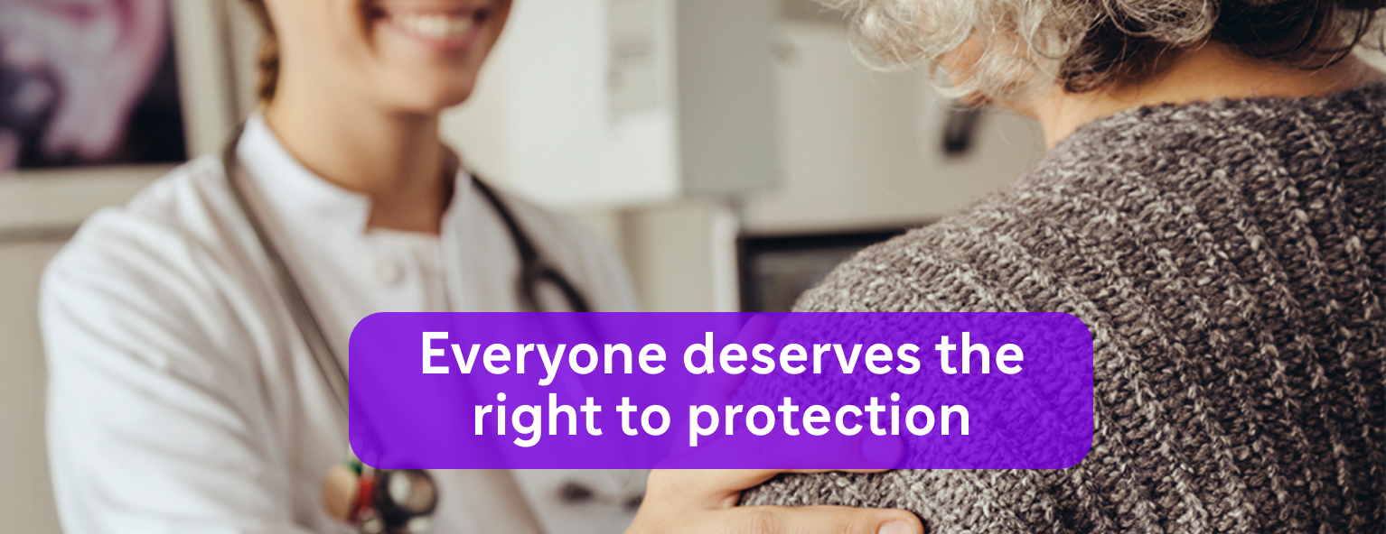 A healthcare professional smiling and comforting a patient