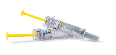 Two medical syringes with yellow plungers and labeled text on them.