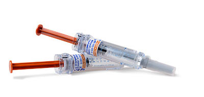 Two medical syringes with red plungers and labeled text on them.