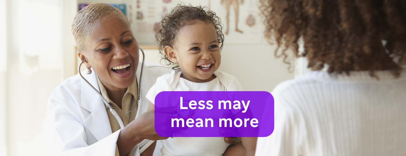 Healthcare professional using a stethoscope on a baby, while the baby smiles at its mother