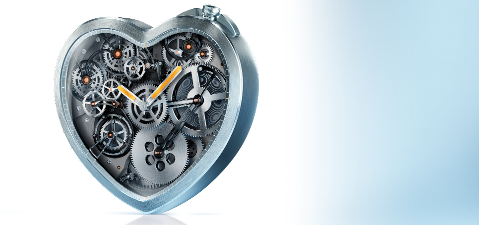 Heart-shaped mechanical clock with visible gears and moving hands