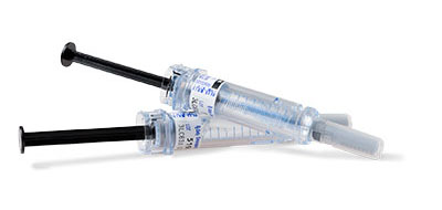 Two medical syringes with black plungers and labeled text on them.